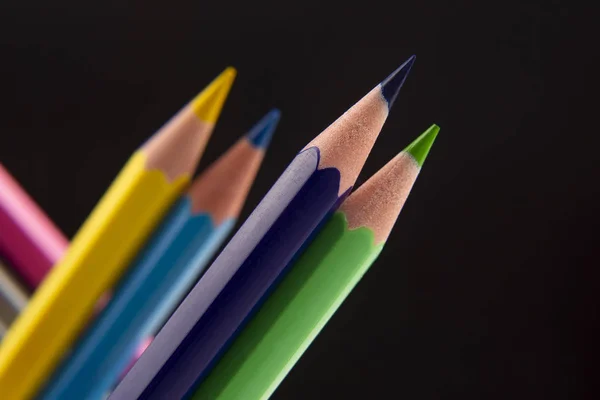 Colored pencils on a dark background. Education and creativity. — Stock Photo, Image