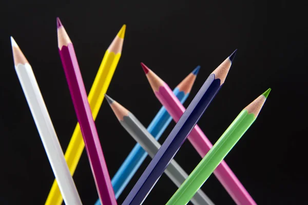 Colored pencils on a dark background. Education and creativity. — Stock Photo, Image