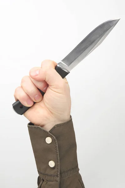 Mano maschile tiene un coltello su uno sfondo bianco — Foto Stock
