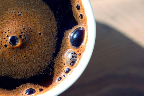 Café negro recién hecho en una taza blanca a la luz del sol . —  Fotos de Stock