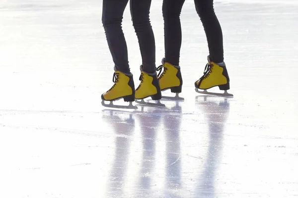 Pés em patins vermelhos em uma pista de gelo. Desporto e entretenimento. Descanso — Fotografia de Stock