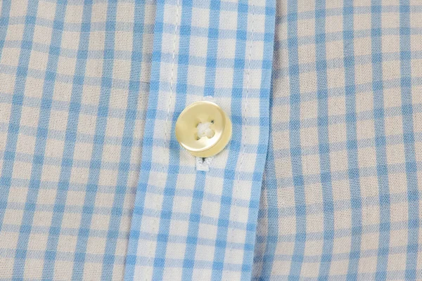 Shiny plastic button on the shirt. Fashion and clothing. Factory industry.