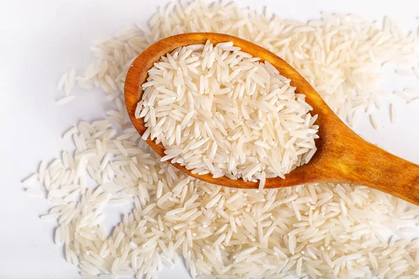 Pile of  basmati rice in a wooden spoon.