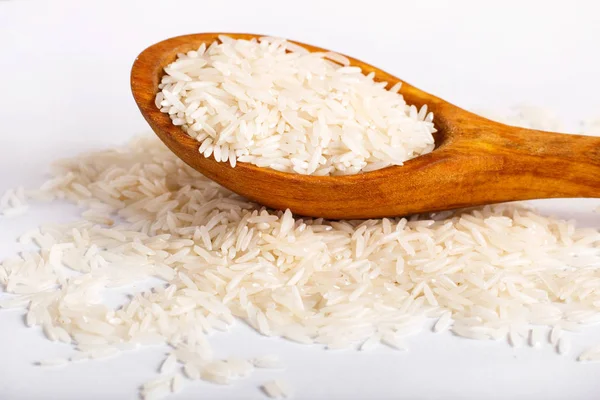 Pile of  basmati rice in a wooden spoon.