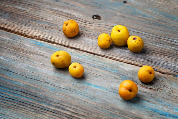 yellow fruits on a blue wooden background
