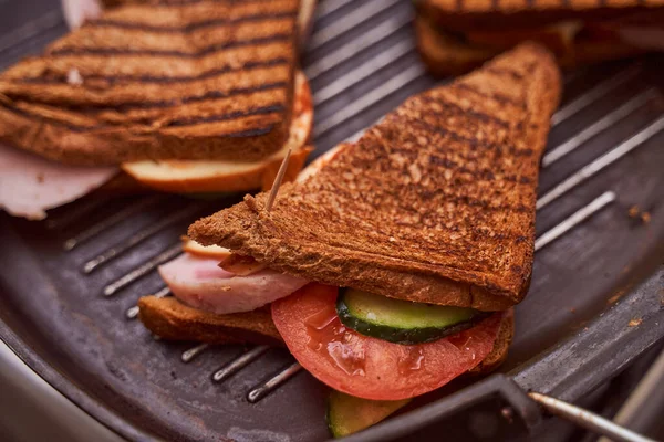 Homemade sandwiches lie on the groa grill. High quality photo