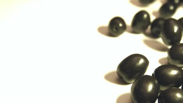 Black Olives White Background Shots Slow Motion Close Olives Rolling — Stock Video