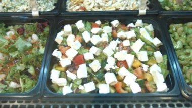 Çeşitli Salatalar kümesi. Süpermarket Salatalarda: deniz ürünleri salatası, karides ve Avokado salatası, Yunan salatası, Çin salatası, salata yeşillikleri ve sebze.