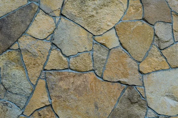 Background of a stone wall cladding texture, brown stone bricks