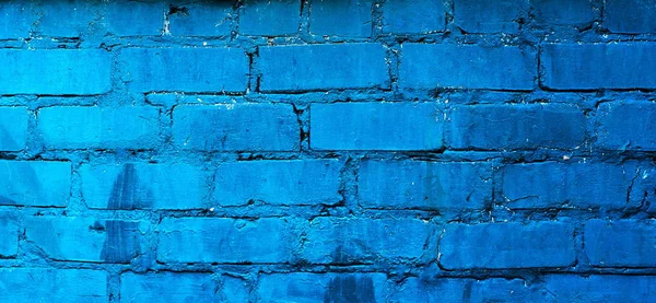 Texture of old blue brick wall surface with cement seams