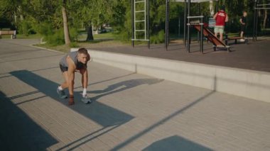 Energetic young male athlete sprinting on a sunny day at an outdoor urban fitness park, showcasing speed, agility, and determination. Young Male Athlete Sprinting Outdoors at Urban Fitness Park