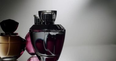 A close-up shot of three elegant perfume bottles with varying designs and colors under soft, stylish lighting. Perfect for beauty, luxury, and fragrance-related concepts. Elegant Perfume Bottles