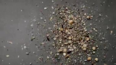 Assorted nuts and seeds fall on a gray surface, depicting a healthy food concept and nutritious snacks. Healthy Cereals and Nuts Flying in Air on Dark Background for Food Concept