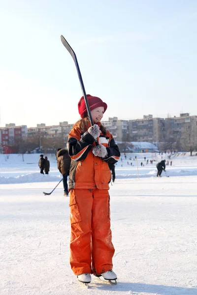 Smiling Little Girl Orange Overalls Skating Rink Skates Hockey Stick — Stock Photo, Image