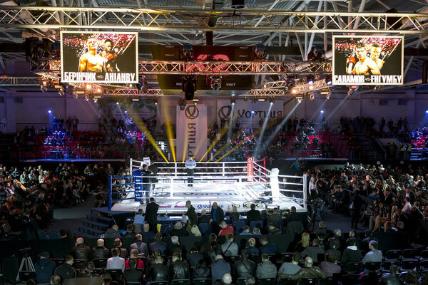 Brovary. Ukraine, 14.11.2015 Empty boxer ring before boxing match. Scoreboards with annonce of the match are over the boxing ring. Refferi in the center of the ring