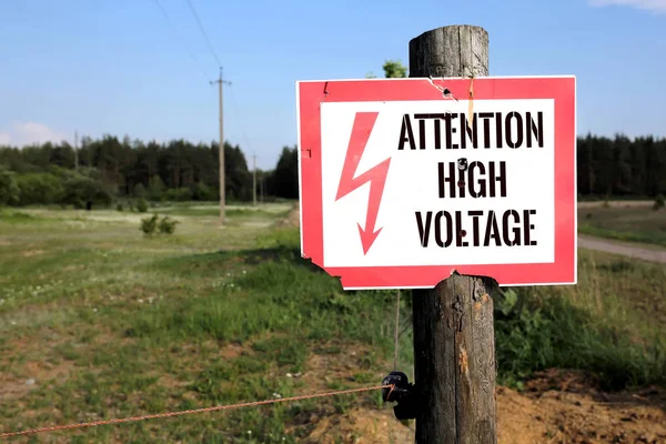 High Voltage Warning Sign posted on a telephone pole