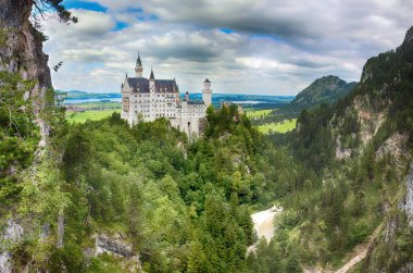 Panoramik dünyaca ünlü Neuschwanstein Şatosu, 19ncu yüzyıl eski Romanesk Revival Saray Kral Ludwig II için Fussen, yanında doğal dağ manzarası ile Güneybatı Bavyera, Almanya inşa