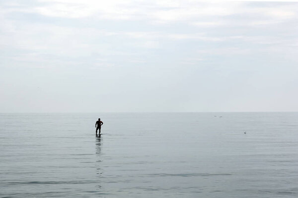Man is on the breakwater in the see