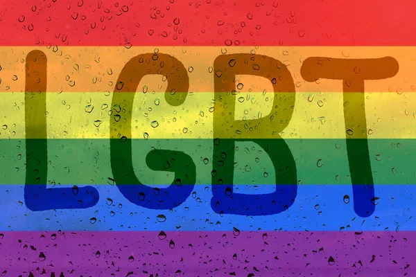 Rainbow flag on background with raindrops and inscription LGBT. LGBT community concept.