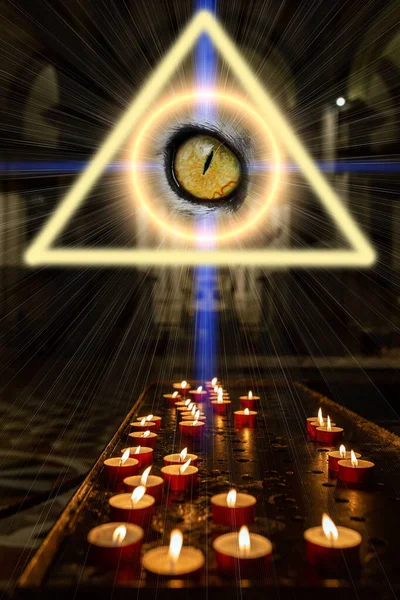The concept of massism of occultism and magic. A triangle shines above with an eye inside and a magic circle from which rays of light emanate. Candles are burning in a dark church.
