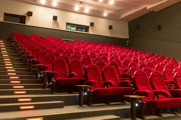 Empty cinema with red-black rows of seats.