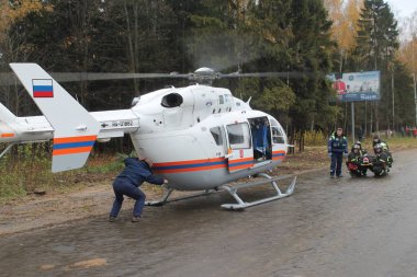 Medical helicopter is getting ready to accept the injured / Traffic Accident Training October 28, 2015 in the Moscow region clipart