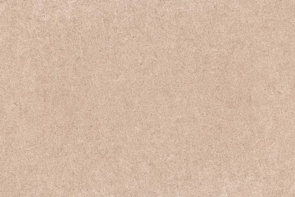 Cardboard background, uniform sheet of rough paper, beige texture of recycled eco-friendly cardboard