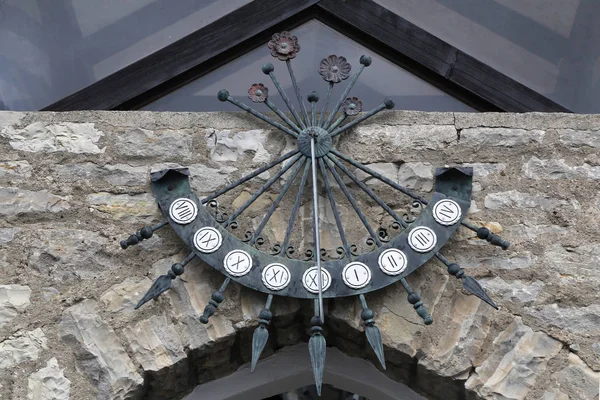 Sundial at the gates of the house