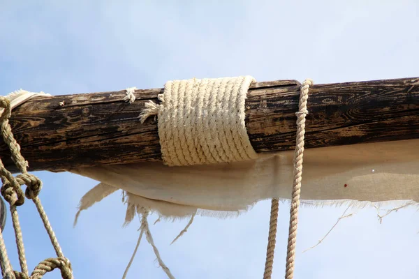 Sails of a pirate ship on a background of blue sky