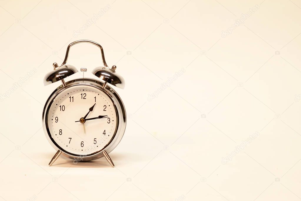 The old alarm clock on a light background