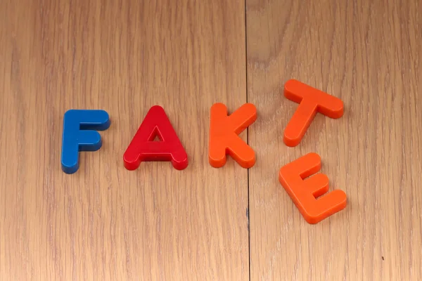 Fact or Fake. Words are made of plastic letters.