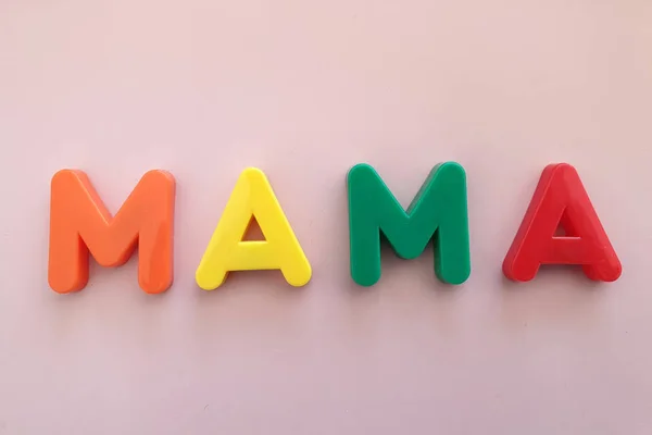 The first words that children spread out from toy plastic letters — Stock Photo, Image