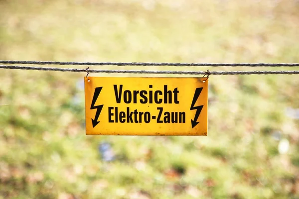 Electric fence with sign Caution, electric fence!