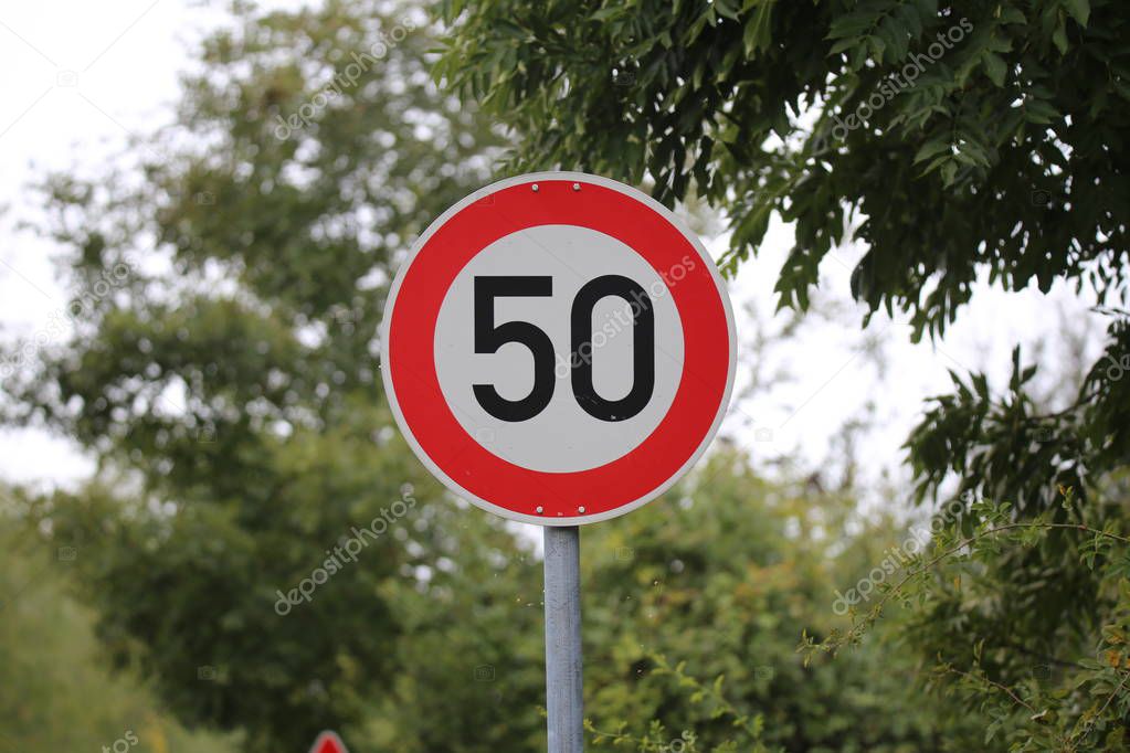 Round speed limit road sign on the road