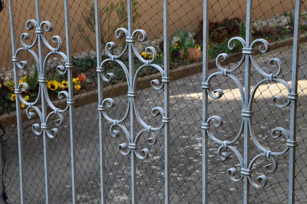 Metal fence. Metal curly fence in the park