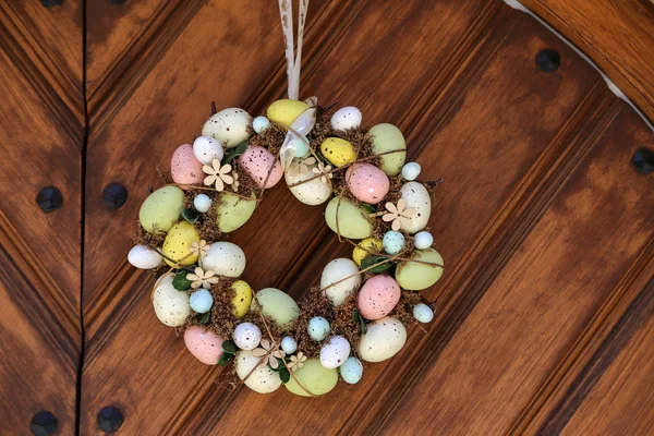 Easter egg wreath hangs on the door — Stock Photo, Image