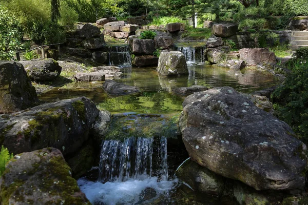 Beautiful waterfalls in the City Park in spring — Stock Photo, Image
