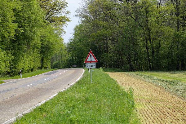 Warning road sign on the edge of the road