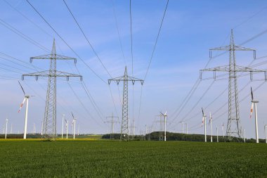 Landscape with high-voltage masts against the blue sky clipart