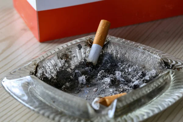 Cigarette butt thrown into an ashtray close up — Stock Photo, Image