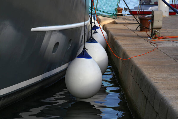 Mooring fender hangs on a boat, close-up