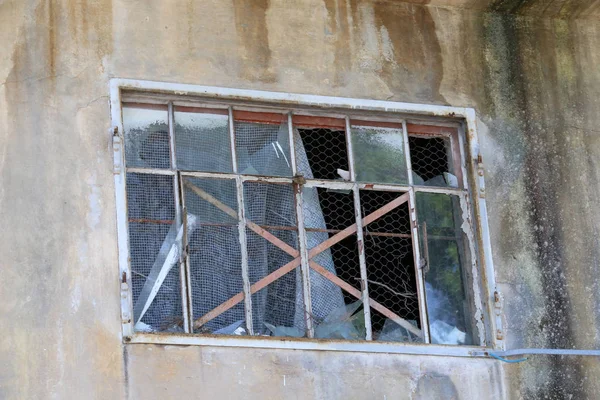 Window with broken windows in an abandoned house