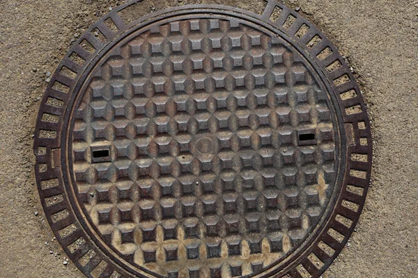 Close-up metal manhole cover, texture background, top view — Stock Photo, Image