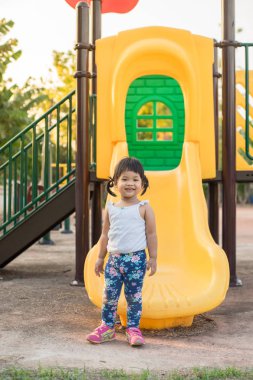 küçük kız ayakta ve gülümseme bahçesi yaz aylarında oynamak için