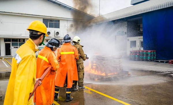 Firefighters fighting fire during training