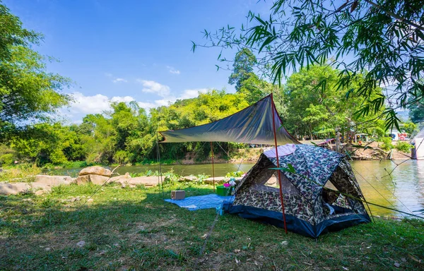 Camping and tent in nature park near the river — Stock Photo, Image