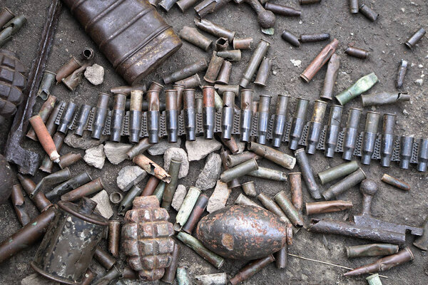 Military background with cartridges of grenades and machine-gun tape. Black archeology. World War II and its artifacts. Great Patriotic War of the USSR