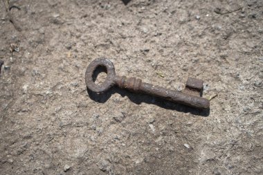 Bir antika paslı metal anahtar beton zemin üzerine. Gizem tarafından korunan romantik bir sır. Stok fotoğraf.