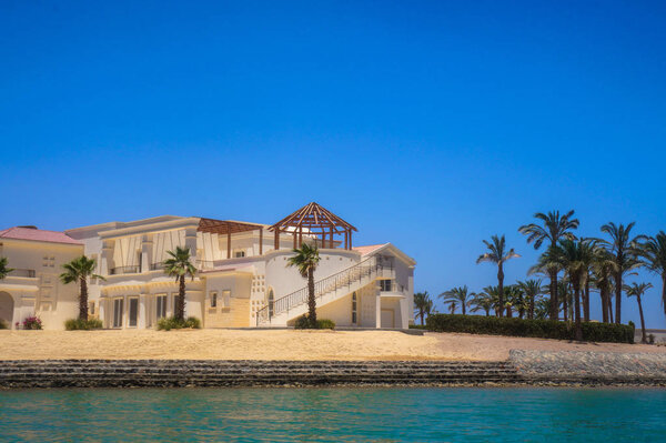 Beautiful view of the coastline with houses and hotels on the red sea. Tourist region in Egypt. Hurghada and its traditions. Stock photo for design