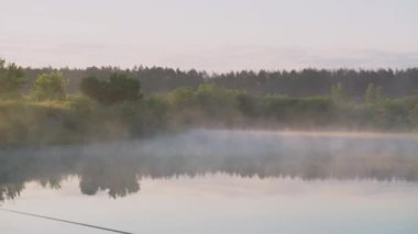 River in the morning in a beautiful fog. Beautiful lake in the evening, sunset against the backdrop of the sun
